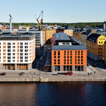 **Image Prompt 1: The Economic Pulse of a Swedish City**
    A dynamic, bustling cityscape in a modern Swedish setting, showcasing a blend of new residential complexes, vibrant commercial districts, and active construction sites. The image should convey growth and optimism, with diverse people moving through revitalized areas, new businesses (like cafes and local shops) thriving, and perhaps a subtle visual element symbolizing economic uplift and increased demand for services.